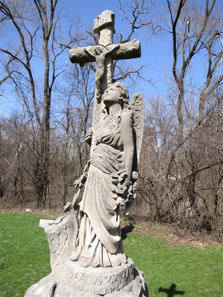 All Saints Parish Cemetery Chicago IL sandstone angel statue w jesus on cross
